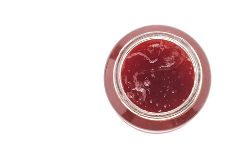 Strawberry jam jar isolated on white backgroundの写真素材