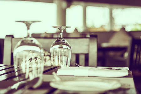 Wine glass on table in restaurant - vintage filterの写真素材
