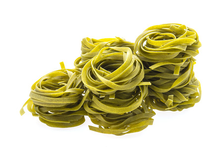 Dry green pasta isolated on white backgroundの写真素材