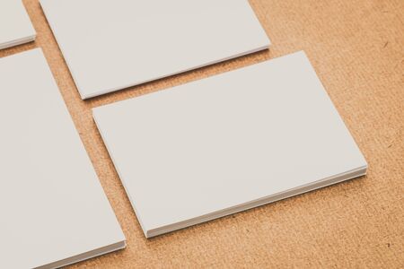 White paper mock up on wood background - vintage filter