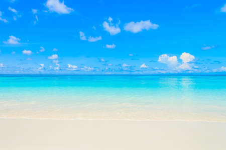 Beautiful sea wave on the beach with blue sky backgroundの写真素材
