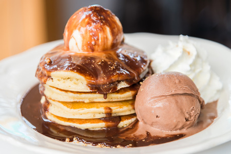 Chocolate pancakes with ice cream on top - soft focus pointの写真素材