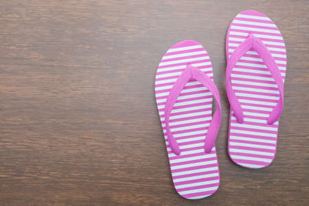 Flip flop on wooden backgroundの写真素材