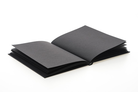 Black note book paper isolated on white backgroundの写真素材