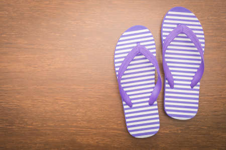 Flip flop on wooden backgroundの写真素材