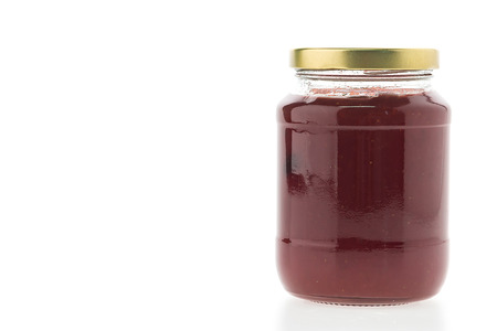 Strawberry jam jar isolated on white backgroundの写真素材