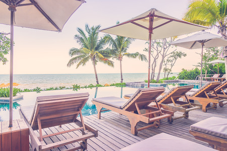 Resort pool with umbrella and chair - vintage filter effectのeditorial素材
