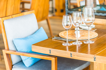 Wine glasses on dining table in restaurantの写真素材
