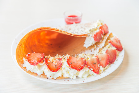 Crepe dessert with strawberry fruit and whipping creamの写真素材