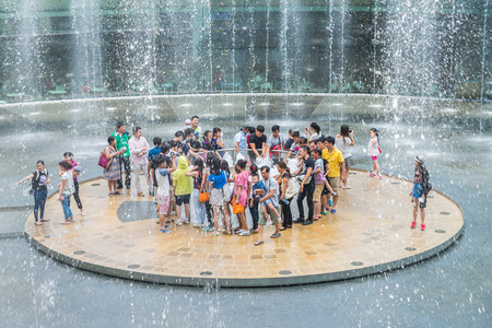 SINGAPORE-JULY 18: Fountain of Wealth with Suntec Towers at dusk on JULY 18,2015 in Singapore. Fountain of wealth is the biggest fountain in Singapore located Suntec Towers, SINGAPORE.のeditorial素材