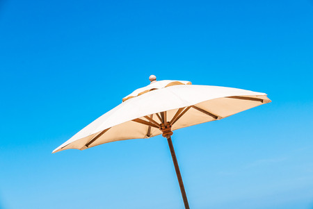 Umbrella bed deck on tropical beach with blue skyの写真素材