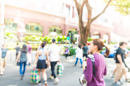 Blur people in rush hours at orchard road background with sunflare effect filter processingの写真素材