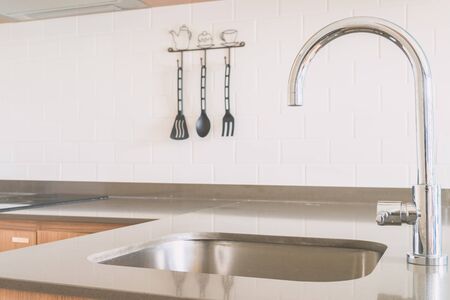 Faucet sink at kitchen - vintage light tone filterの写真素材