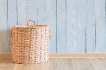 Wicker basket in the empty room - light vintage filter effectの写真素材