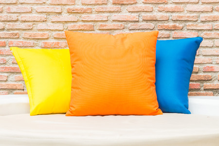 Colorful pillow on bed at hotel resort swimming poolの写真素材