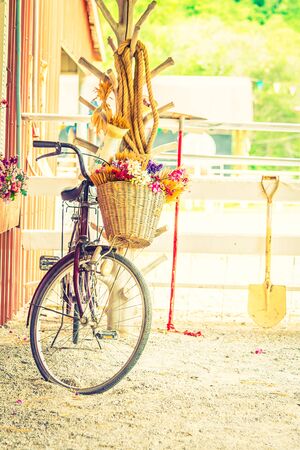Vintage bicycle with flower on basket - vintage filterの写真素材