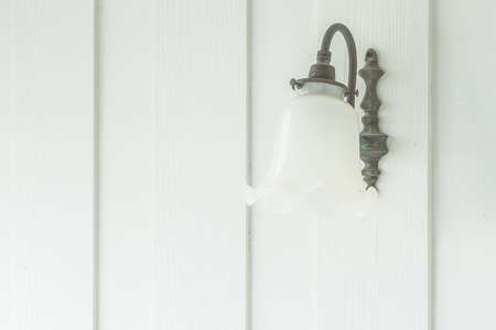 Vintage lantern on white wall background - vintage light filter effectの写真素材