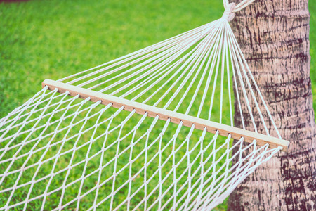 Selective focus point on hammock with green grass background - Filter effect processingの写真素材