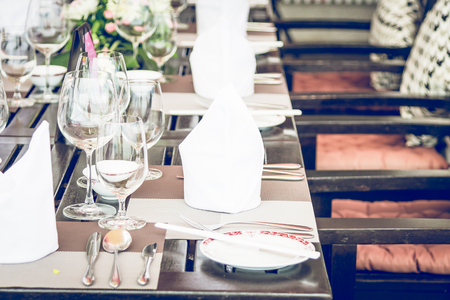 Table dining set in the hotel restaurant - light vintage filter effect processing style pictures - Selective focus pointの写真素材