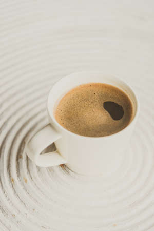 Selective focus point on black coffee in white cup - vintage filter effectの写真素材