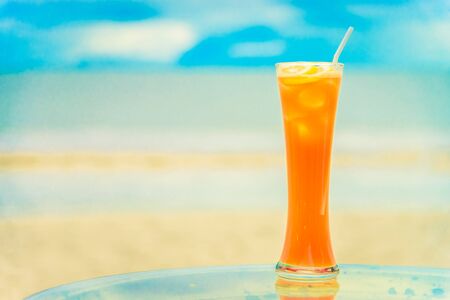 Iced mocktails glass on the beach - vintage filter effectの写真素材