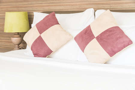 Bed pillow and light lamp in bedroomの写真素材