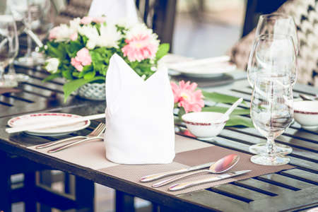 Table dining set in the hotel restaurant - light vintage filter effect processing style pictures - Selective focus pointの写真素材