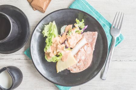 Top of view brakfast dish on wood table - light vintage filter effectの写真素材