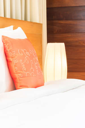 Beautiful luxury bedroom interior with orange pillow decoration in hotel resortの写真素材