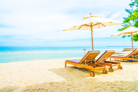 Umbrella and chair on beautiful tropical beach - summer vacation backgroundの写真素材