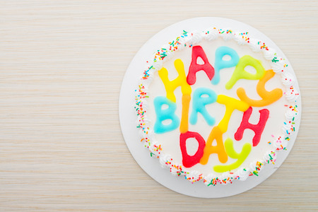 Happy birthday cake on wooden backgroundの写真素材