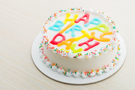 Happy birthday cake on wooden backgroundの写真素材