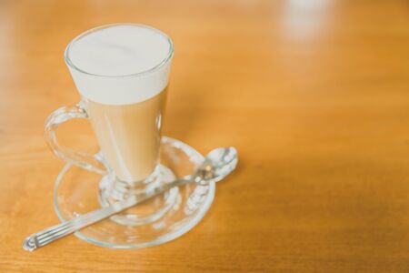 Hot latte coffee cup in coffee shop cafe - vintage filterの写真素材