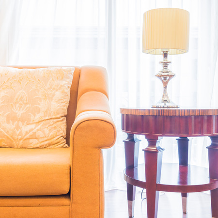 Sofa with pillow and light lamp decoration in living room interiorの写真素材