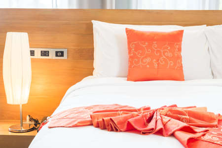 Beautiful luxury bedroom interior with orange pillow decoration in hotel resortの写真素材