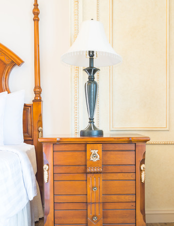 White Pillow on bed and light lamp decoration in hotel bedroom interiorの写真素材