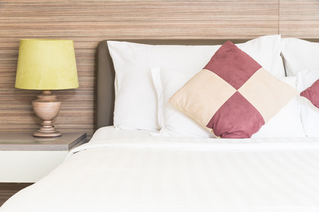 Bed pillow and light lamp in bedroomの写真素材