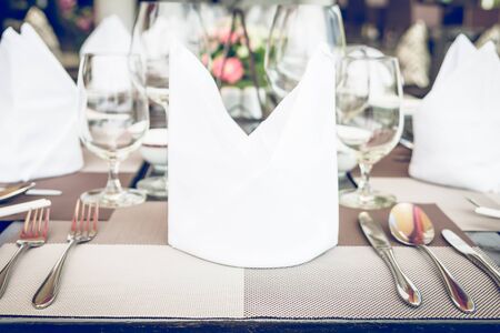 Table dining set in the hotel restaurant - light vintage filter effect processing style pictures - Selective focus pointの写真素材