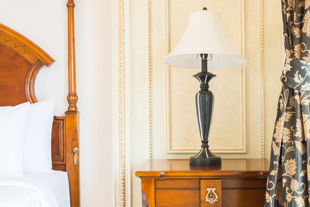 White Pillow on bed and light lamp decoration in hotel bedroom interiorの写真素材