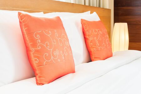 Beautiful luxury bedroom interior with orange pillow decoration in hotel resortの写真素材