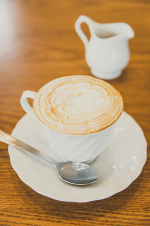 White Coffee cup in coffee shop cafe interior - vintage filterの写真素材