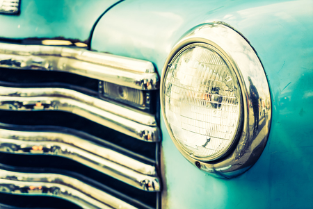 Selective focus point on Headlight lamp car - vintage filterの写真素材