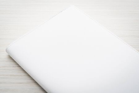 Blank white mock up book on wooden background - filter effect processingの写真素材