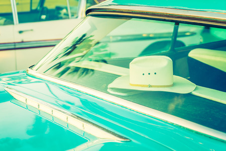 Hat inside of vintage car - vintage filterの写真素材