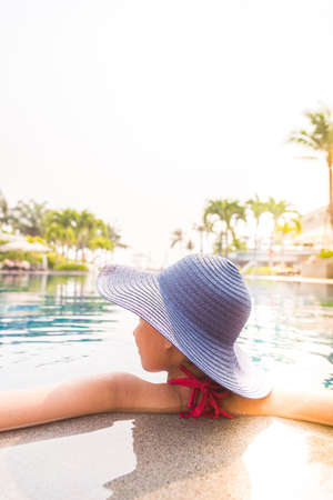 Woman in swimming pool - vintage filter and light leak effect processingの写真素材