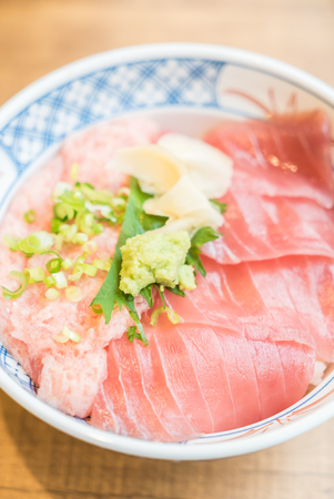Raw fish tuna meat on top of rice bowl - japanese style foodの写真素材