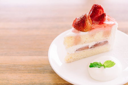 Soft focus on Strawberry cream cake in white plate - filter effect processing