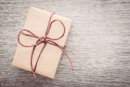 Vintage Brown gift box on wooden background - vintage filter processingの写真素材