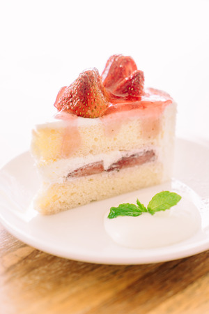 Soft focus on Strawberry cream cake in white plate - filter effect processingの写真素材