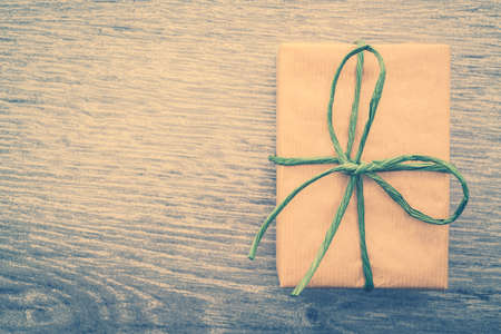Vintage Brown gift box on wooden background - vintage filter processingの写真素材